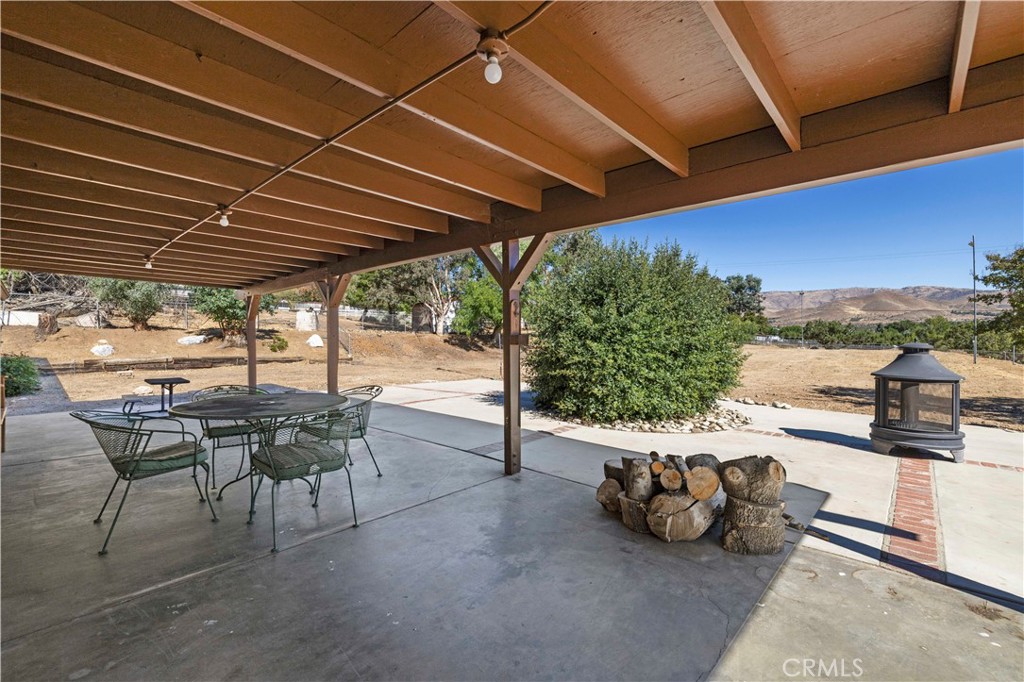 3855 Acton Avenue Acton, CA 93510 - Photo 14 of 21 a view of a patio with table and chairs under an umbrella