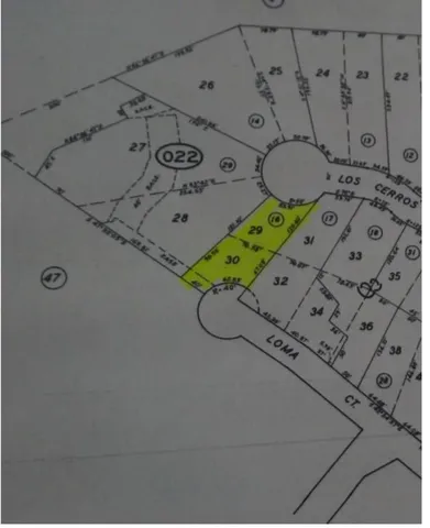 a balcony view with two chairs and a table in the back