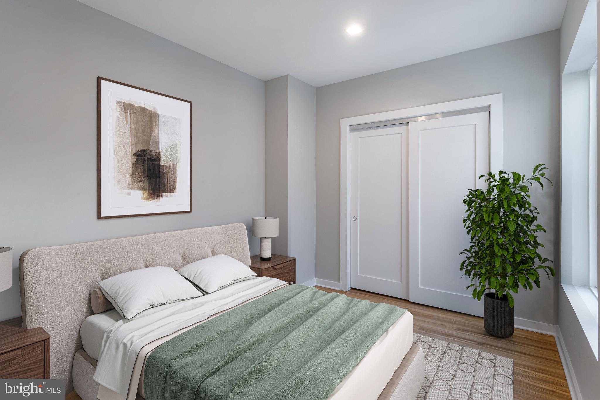 1358 Florida Avenue Northeast, Unit 208 Washington, DC 20002 - Photo 3 of 8 a bedroom with a large bed and a potted plant