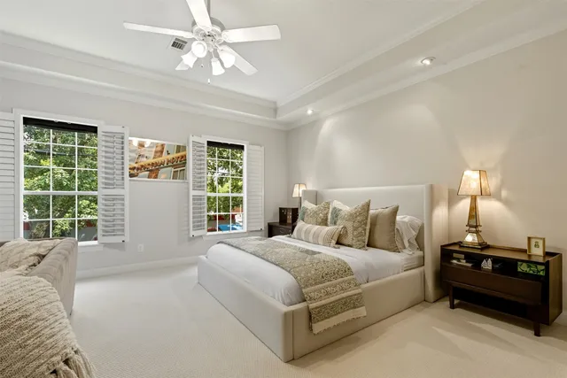 a bedroom with a bed and a large window