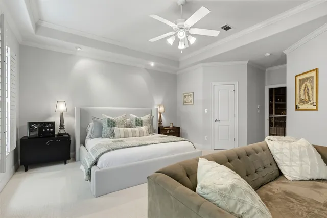a bedroom with a bed and ceiling fan