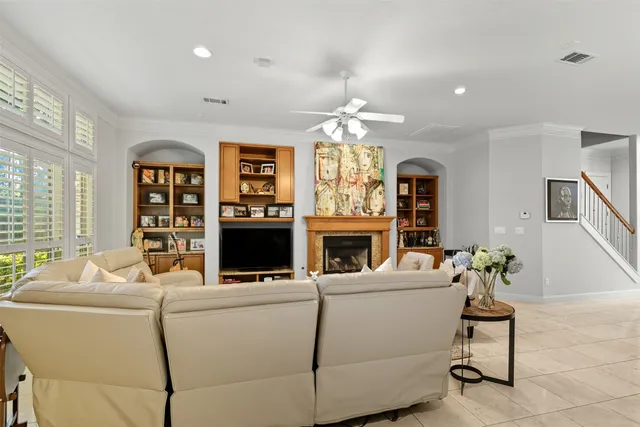 a living room with furniture a chandelier and a fireplace