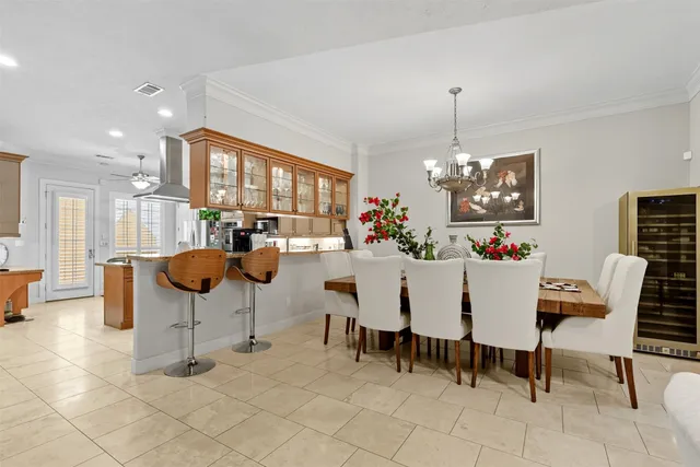 a dining room filled with furniture and a chandelier