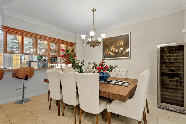 a view of a dining room with furniture and chandelier