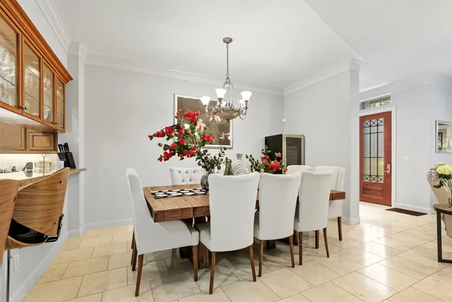 a dining room with furniture a chandelier and window