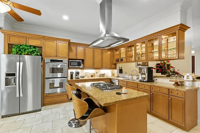 a kitchen with stainless steel appliances granite countertop a stove refrigerator sink and cabinets