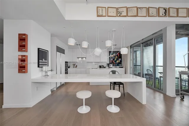 a large kitchen with a table and chairs