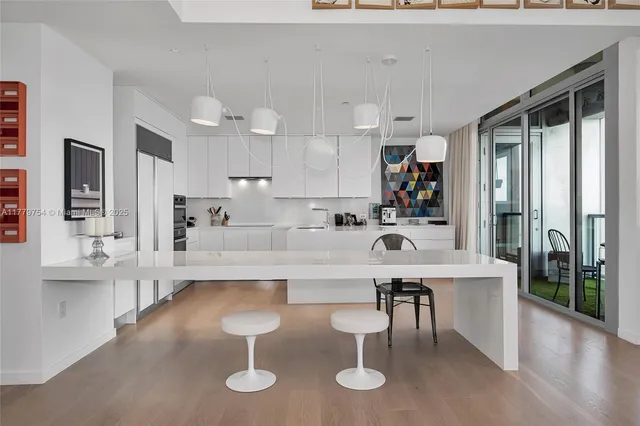 a large kitchen with a table and chairs
