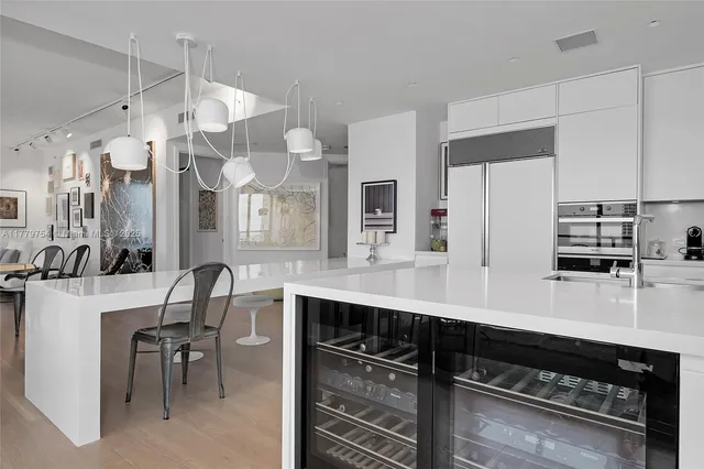 a kitchen with cabinets and chairs