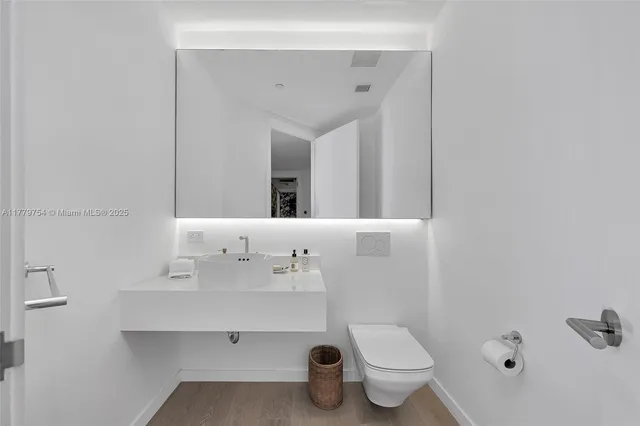 a bathroom with a sink a toilet and a mirror