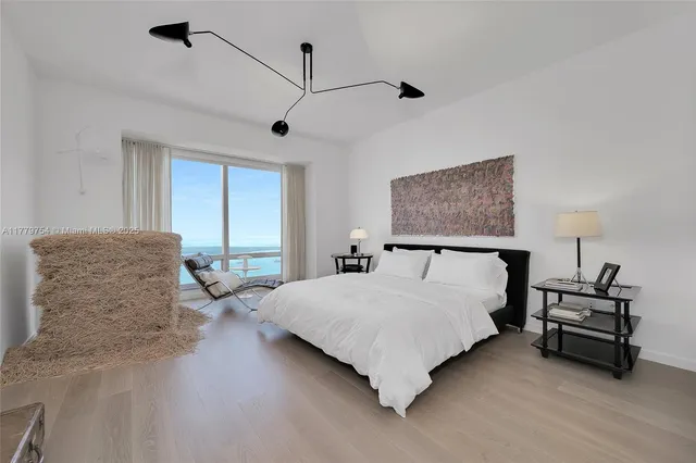 a spacious bedroom with a bed and a dresser