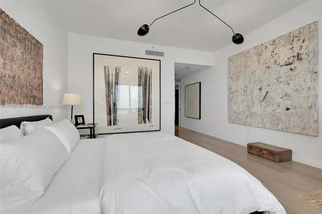 a bedroom with a large bed and a couch