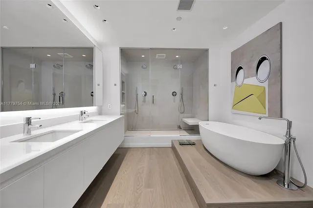 a bathroom with a tub sink and mirror