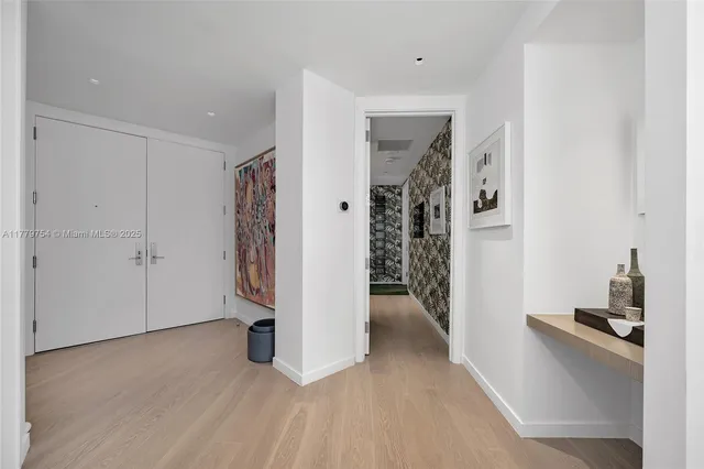 a view of a storage & utility room with closet wooden floor
