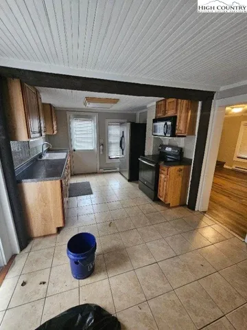a kitchen with a table and chairs