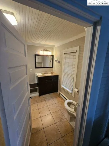 a view of kitchen with stainless steel appliances cabinets and large window