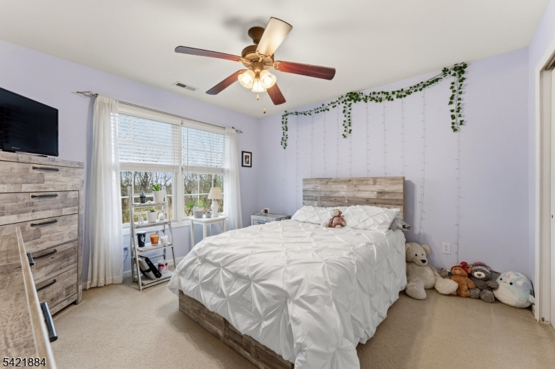 26 Rouser Way Hillsborough, NJ 08844 - Photo 36 of 49 a bedroom with a bed and a chandelier