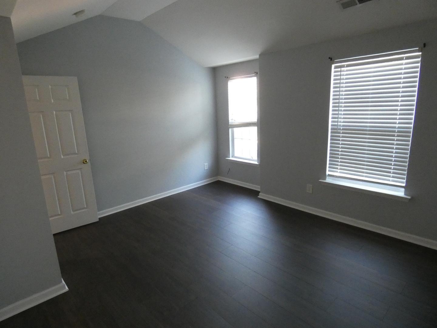 1624 Brown Owl Drive Raleigh, NC 27610 - Photo 19 of 22 an empty room with wooden floor and windows