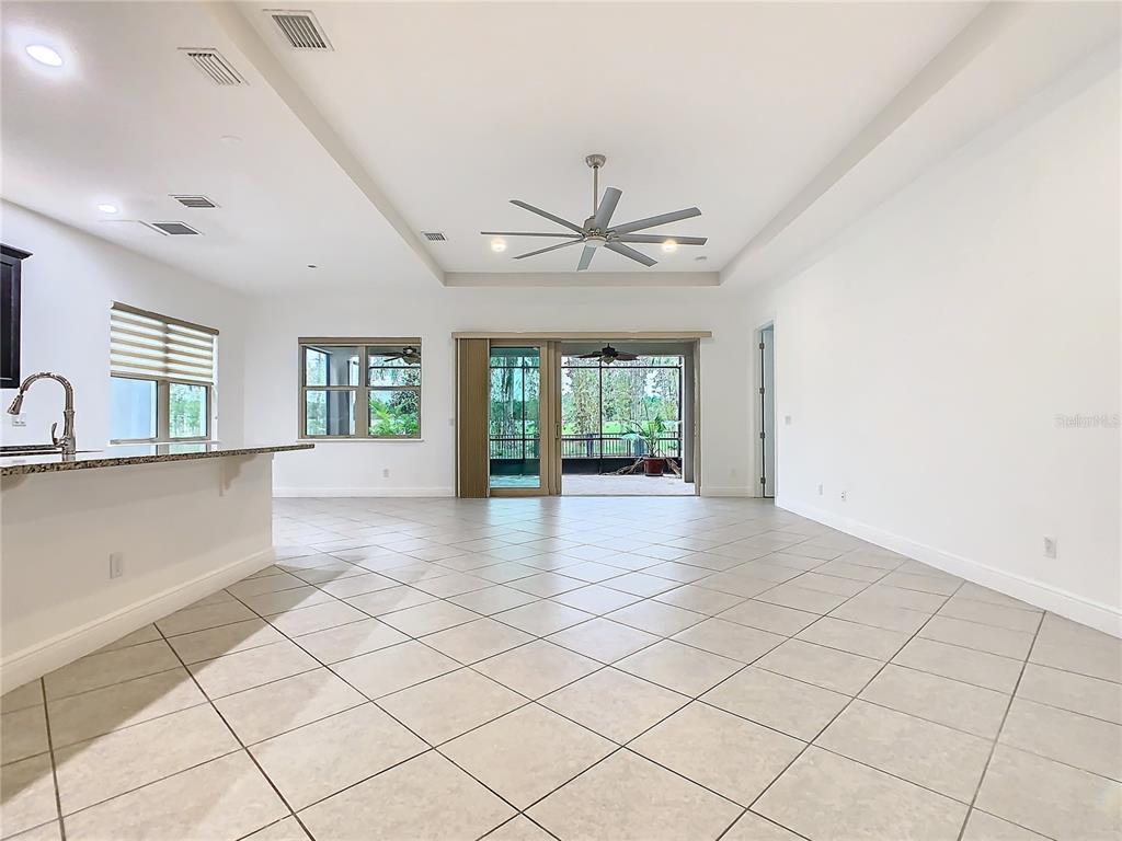 8325 Topsail Place Winter Garden, FL 34787 - Photo 11 of 74 a view of an empty room with a window and a kitchen