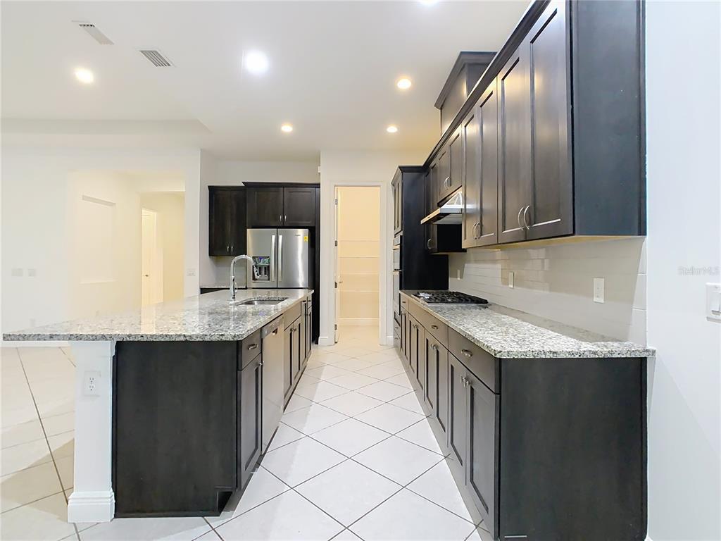 8325 Topsail Place Winter Garden, FL 34787 - Photo 18 of 74 a kitchen with stainless steel appliances granite countertop lots of counter top space