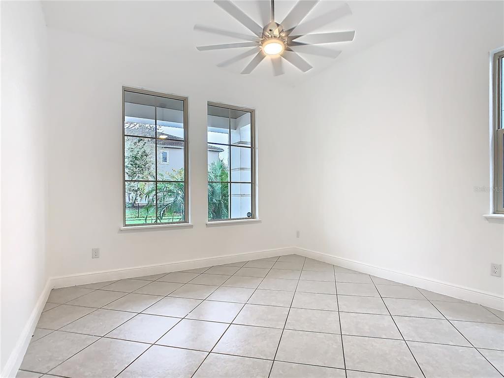 8325 Topsail Place Winter Garden, FL 34787 - Photo 23 of 74 an empty room with windows and ceiling fan
