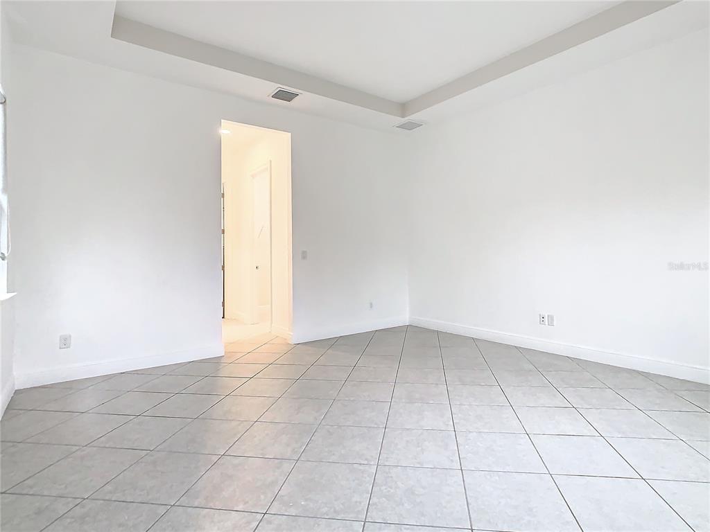 8325 Topsail Place Winter Garden, FL 34787 - Photo 27 of 74 an empty room with white walls and tiles