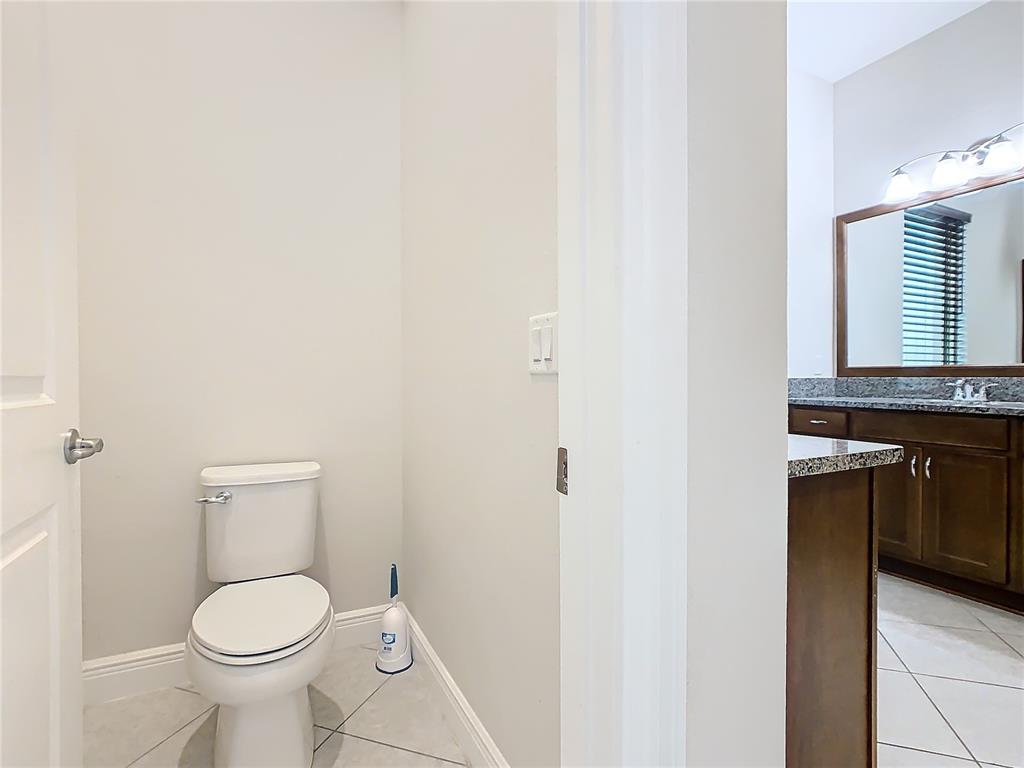 8325 Topsail Place Winter Garden, FL 34787 - Photo 30 of 74 a bathroom with a toilet a sink and mirror