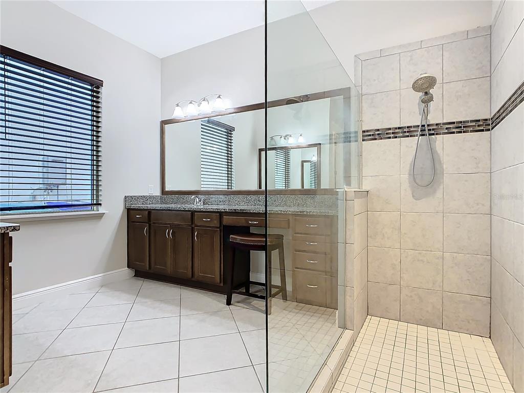 8325 Topsail Place Winter Garden, FL 34787 - Photo 32 of 74 a bathroom with a granite countertop sink a toilet and shower