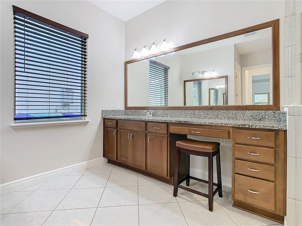 8325 Topsail Place Winter Garden, FL 34787 - Photo 34 of 74 a spacious bathroom with a granite countertop sink and a mirror
