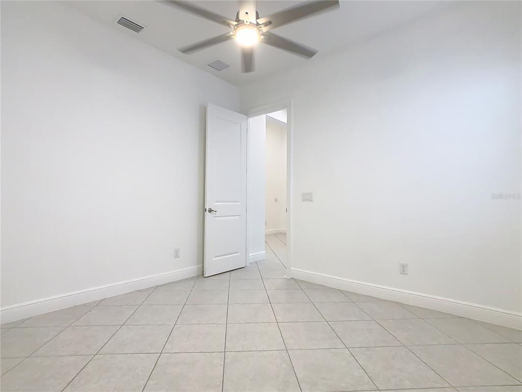 8325 Topsail Place Winter Garden, FL 34787 - Photo 40 of 74 an empty room with a ceiling fan and carpet