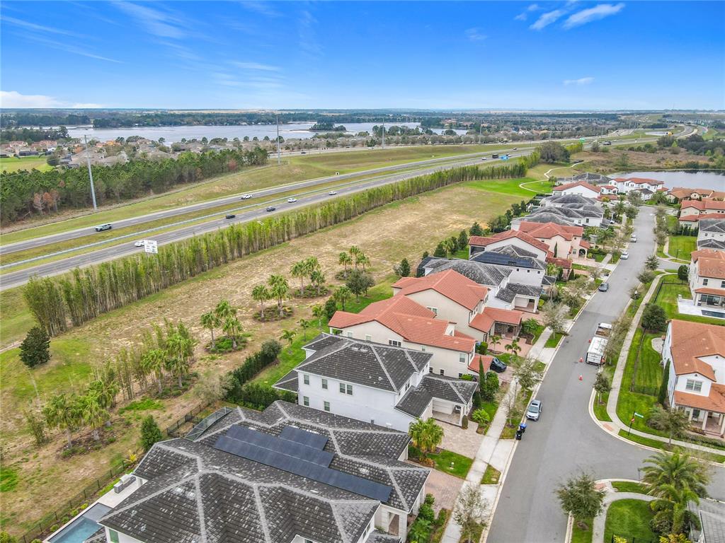 8325 Topsail Place Winter Garden, FL 34787 - Photo 4 of 74 an aerial view of a city with lots of residential buildings and ocean view