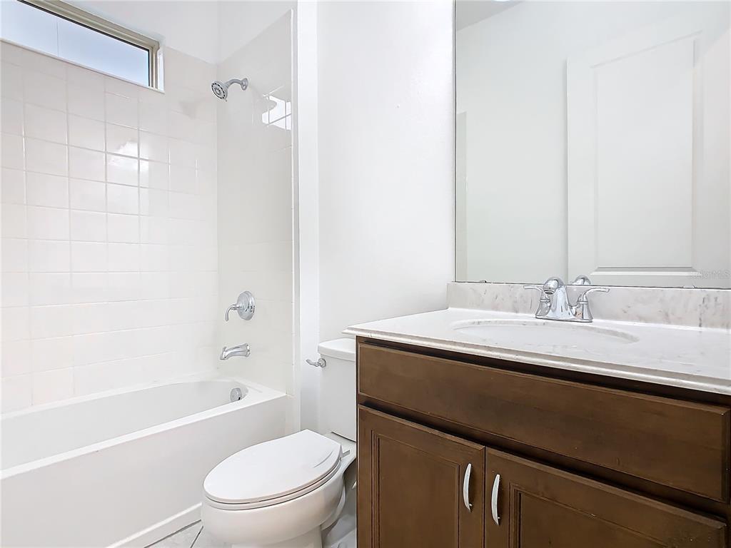 8325 Topsail Place Winter Garden, FL 34787 - Photo 42 of 74 a bathroom with a granite countertop sink toilet and shower