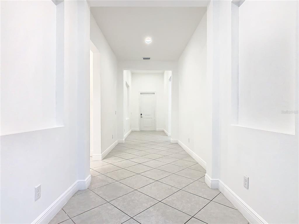 8325 Topsail Place Winter Garden, FL 34787 - Photo 9 of 74 a view of a hallway with wooden floor