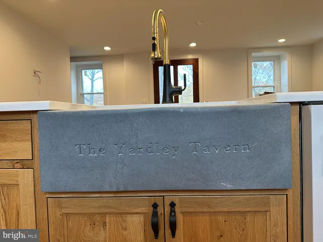 a large kitchen with stainless steel appliances granite countertop a refrigerator a stove and a sink