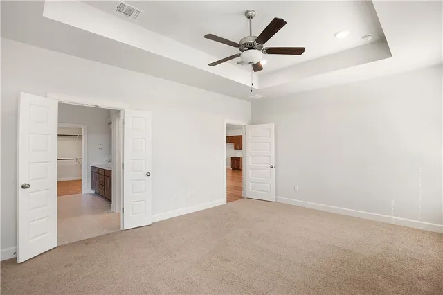 an empty room with closet and windows