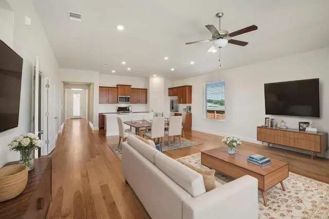 a living room with fireplace furniture and a flat screen tv