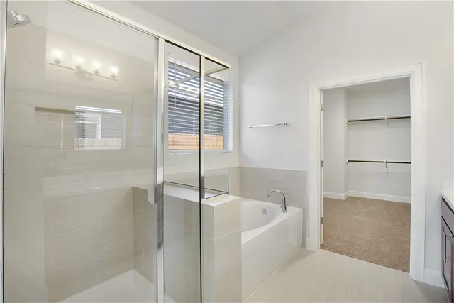 a bathroom with a bathtub and a shower