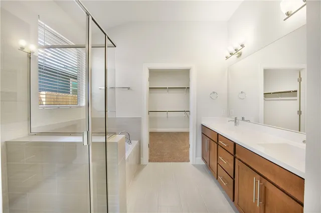 a bathroom with a tub sink and mirror