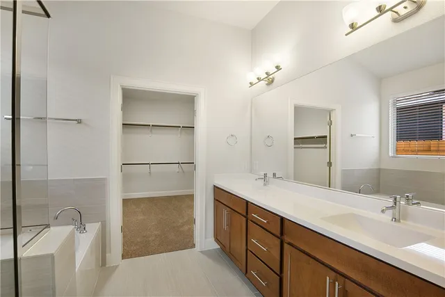 a bathroom with a double vanity sink a toilet and a mirror