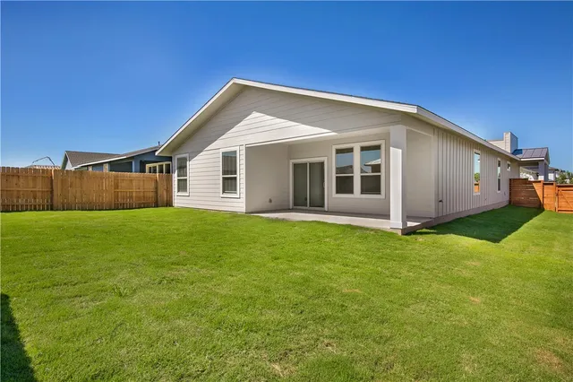 a view of a house with a backyard