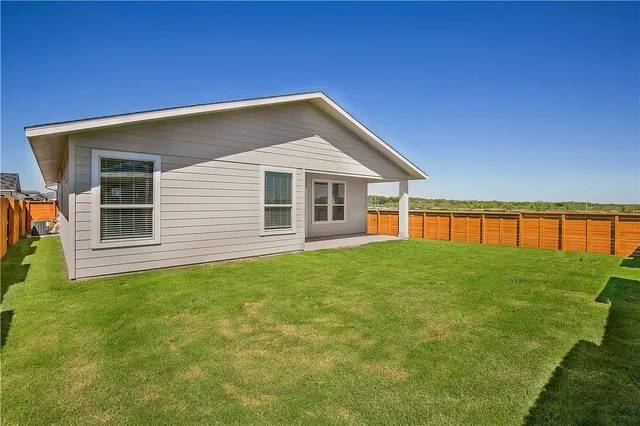 a view of a house with a backyard