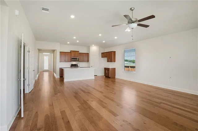 a view of a kitchen with a sink and wooden floor