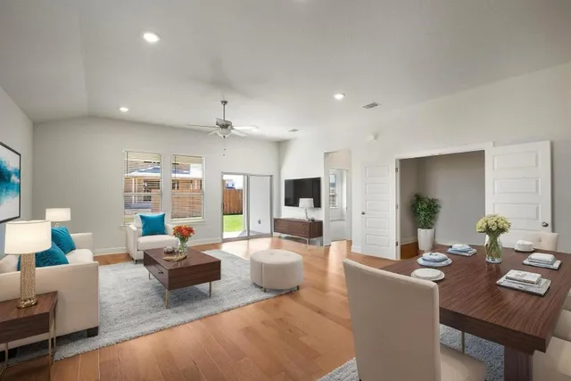 a living room with furniture and view of kitchen