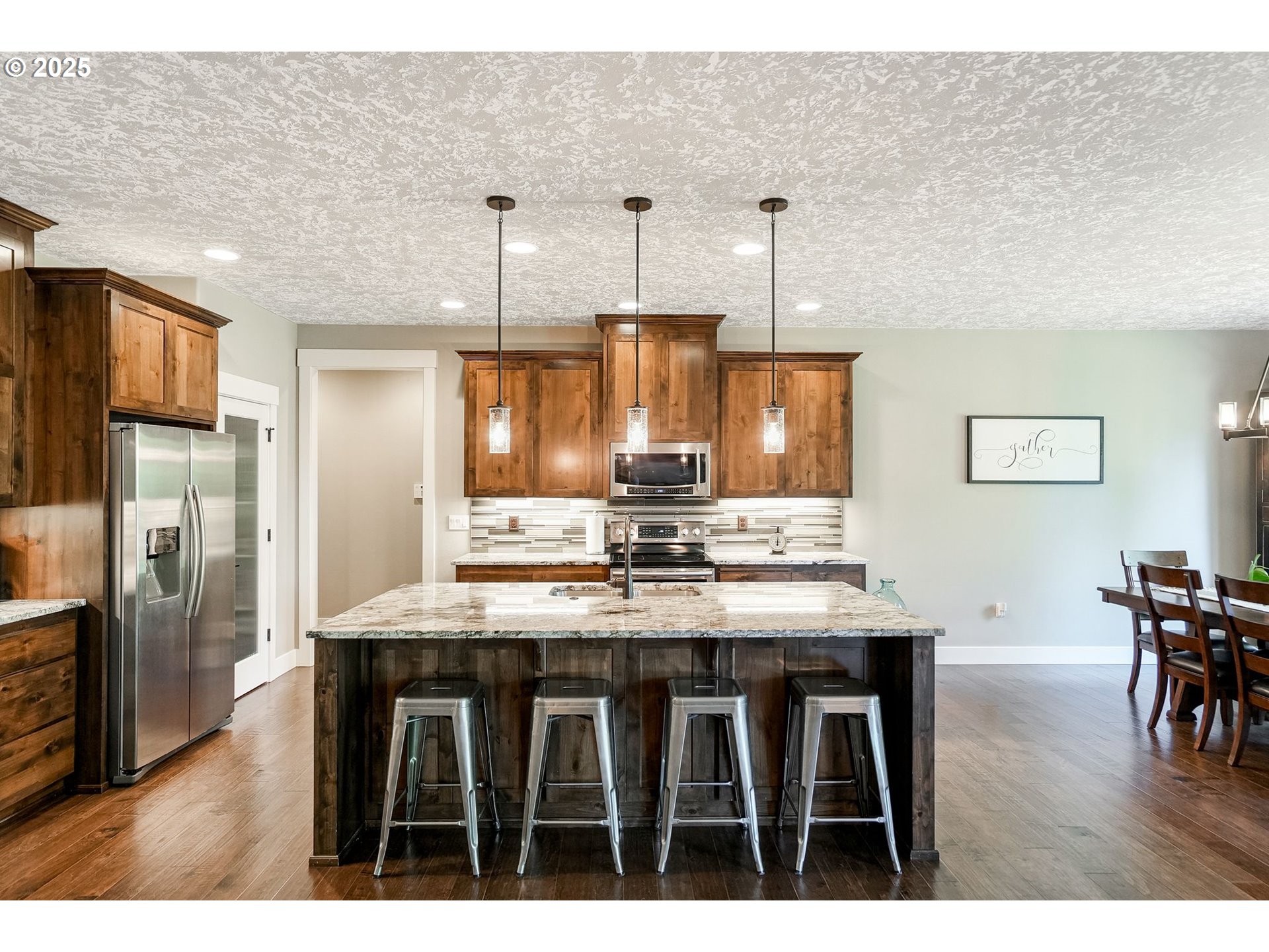 6300 Corvallis Road Independence, OR 97351 - Photo 12 of 48 a kitchen with kitchen island granite countertop a table chairs stainless steel appliances and cabinets