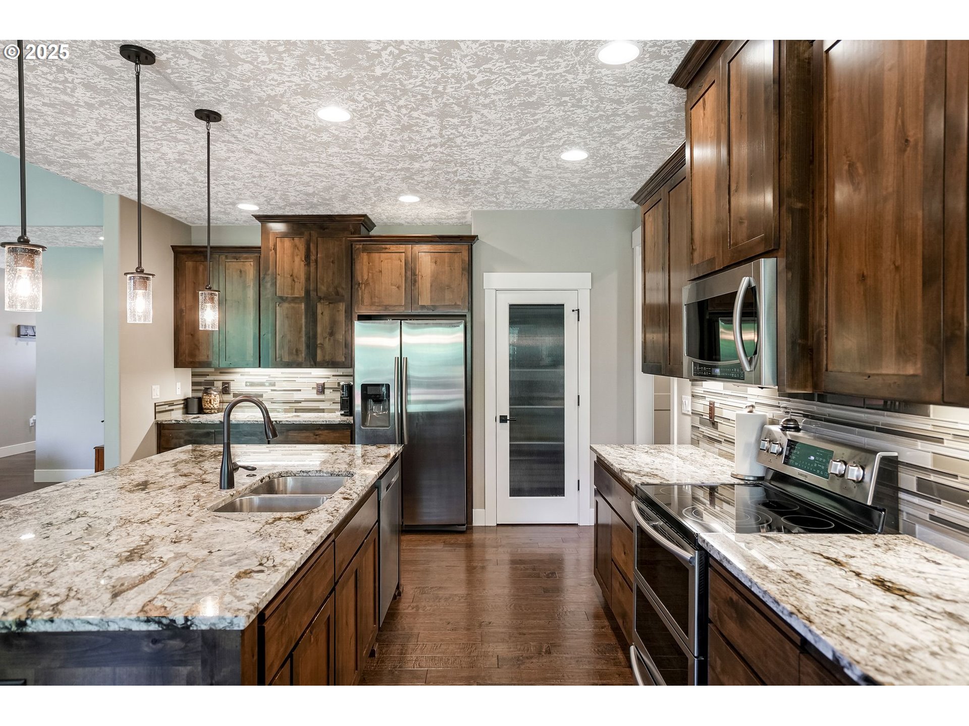 6300 Corvallis Road Independence, OR 97351 - Photo 14 of 48 a kitchen with kitchen island granite countertop wooden cabinets and refrigerator