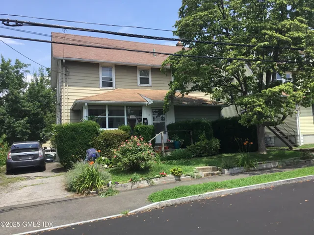 a front view of house with garage and green space