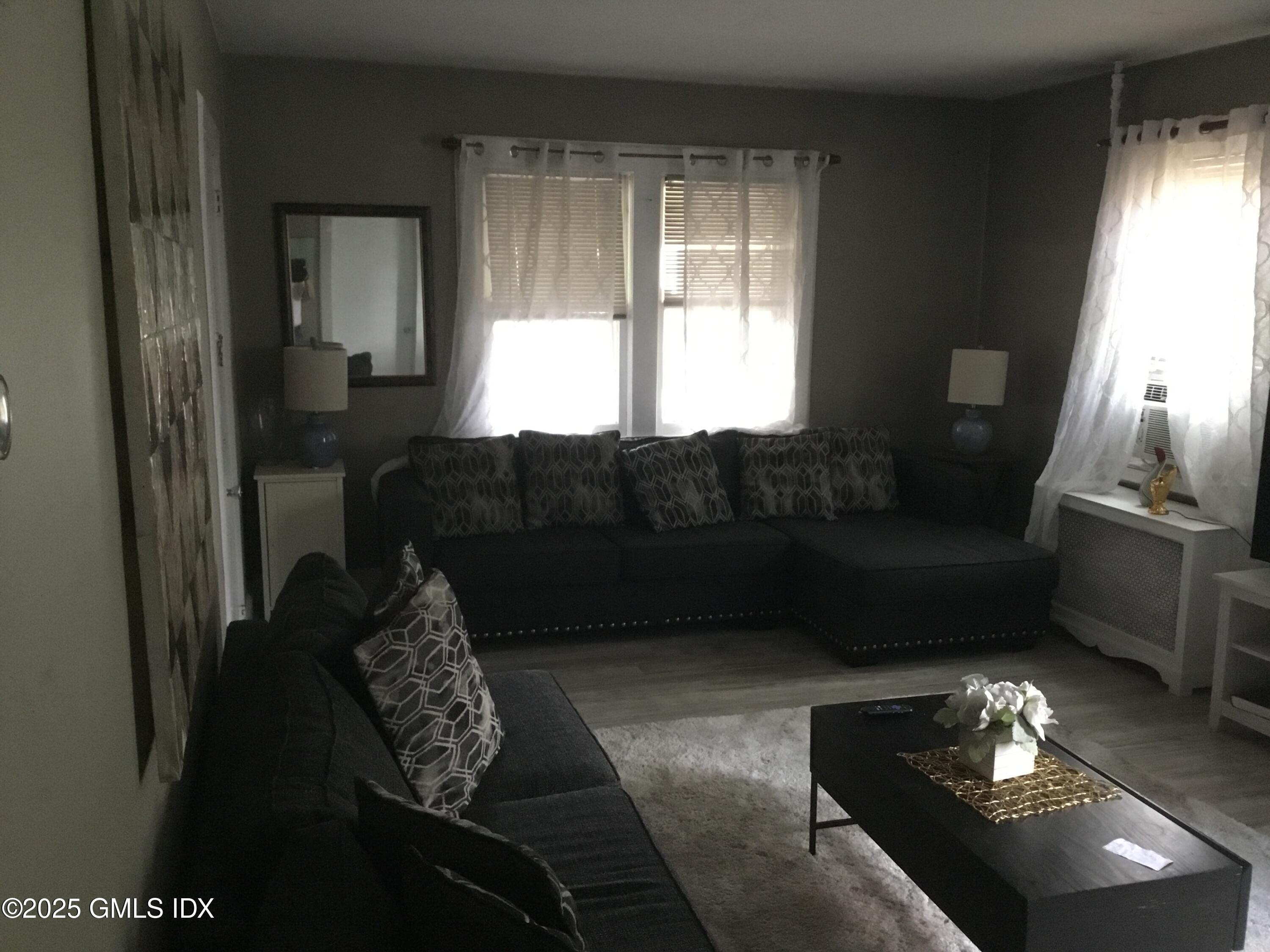 14 Sherman Avenue Greenwich, CT 06830 - Photo 13 of 27 a living room with furniture and a window