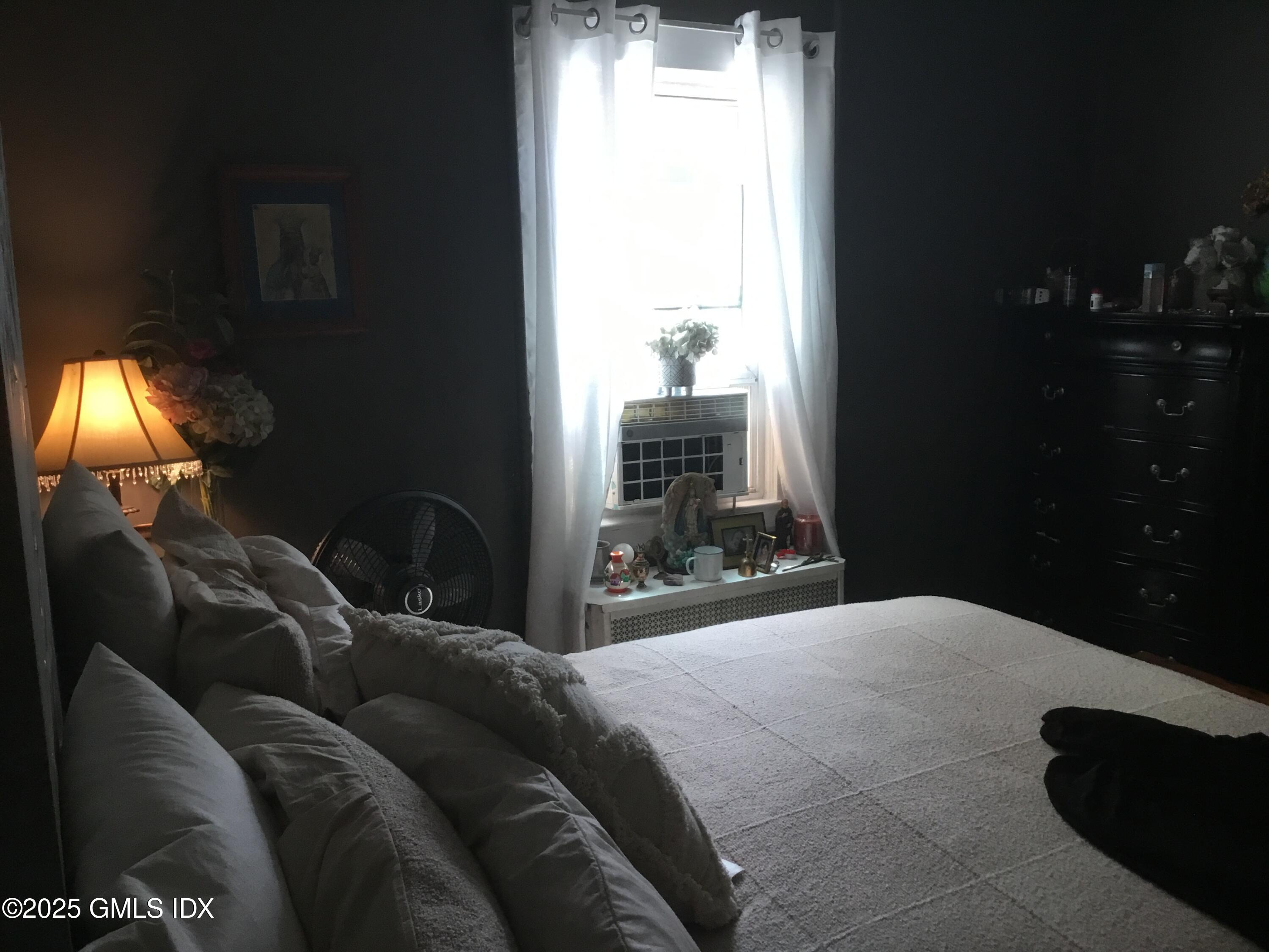 14 Sherman Avenue Greenwich, CT 06830 - Photo 17 of 27 a bedroom with a bed and lamp with window