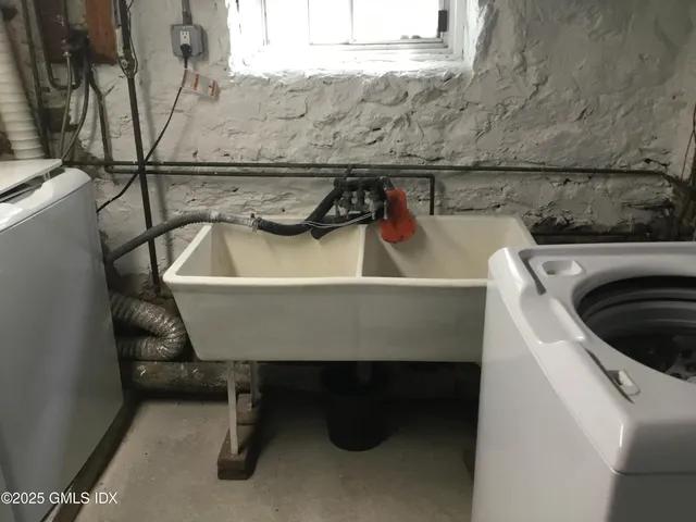 a view of storage and utility room with racks on the wall
