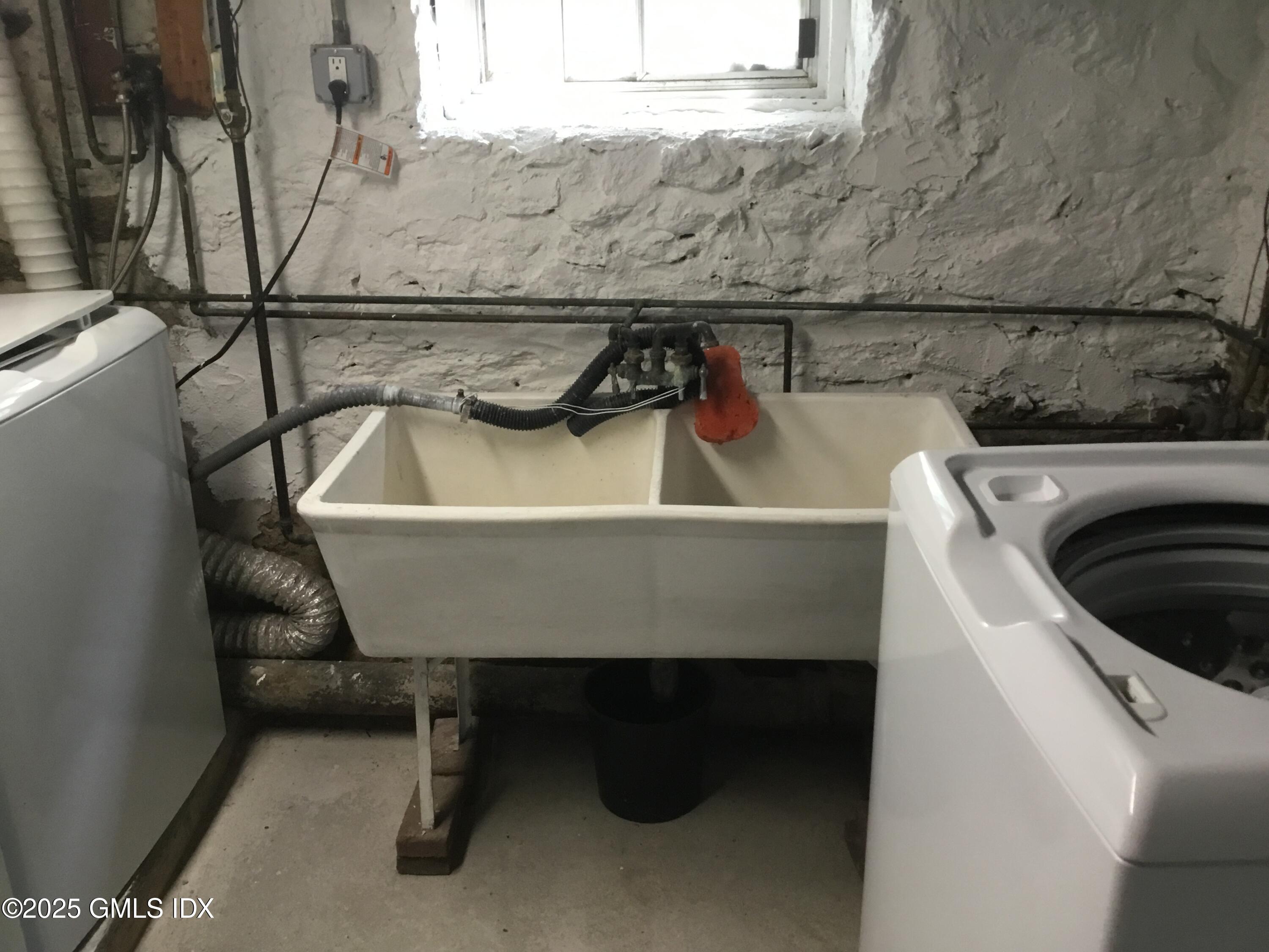 14 Sherman Avenue Greenwich, CT 06830 - Photo 22 of 27 a view of storage and utility room with racks on the wall